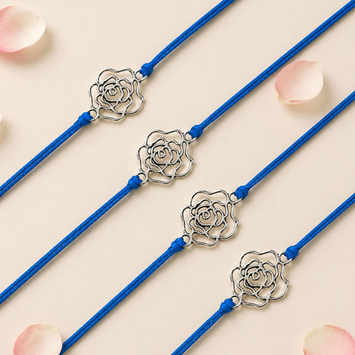 Four blue cord rose charm rakhis with silver toned flowers handmade for brother and bhabhi protection gift