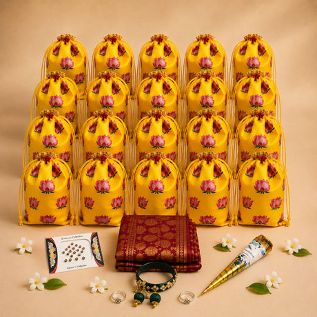 Yellow satin drawstring pouches with pink lotus prints and gold trim for karva chauth gift hamper and festive return gifts
