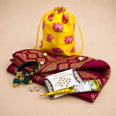 Vibrant yellow drawstring potli bag with pink lotus prints and gold trim for Karva Chauth and festive gift hampers