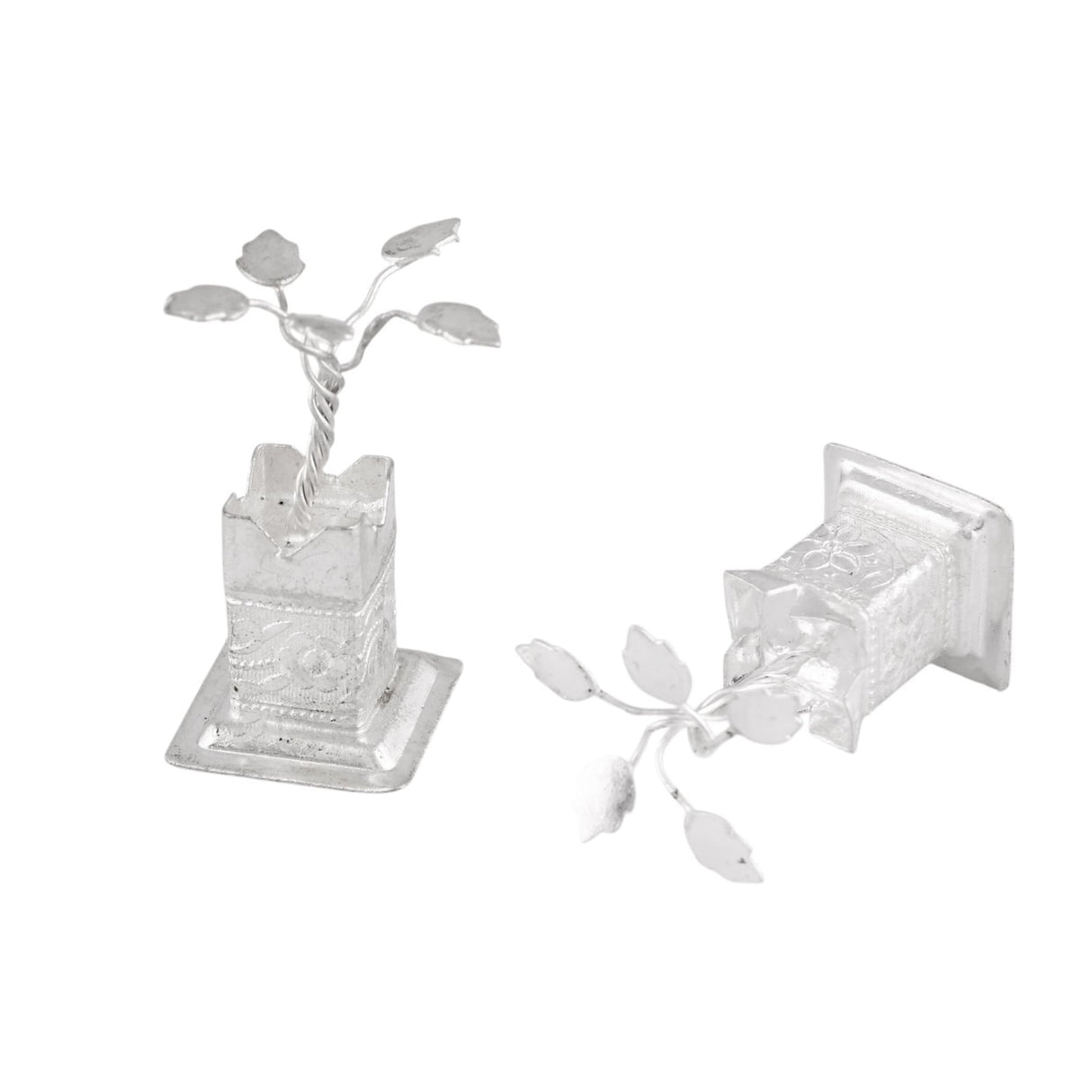 Silver plated miniature tulsi plant figurines with intricate leaf details on ornate bases for home pooja mandir decor