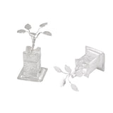 Silver plated miniature tulsi plant figurines with intricate leaf details on ornate bases for home pooja mandir decor