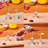 Silver plated tulsi plant figurines with intricate engraved bases and delicate leafy stems for home pooja decor