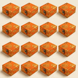 Small handmade orange brocade jewelry boxes with gold floral patterns and metallic clasps for Indian and Pakistani wedding favors