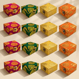 Small handmade square jewelry boxes in magenta green yellow and orange with gold brocade and metallic clasps for weddings