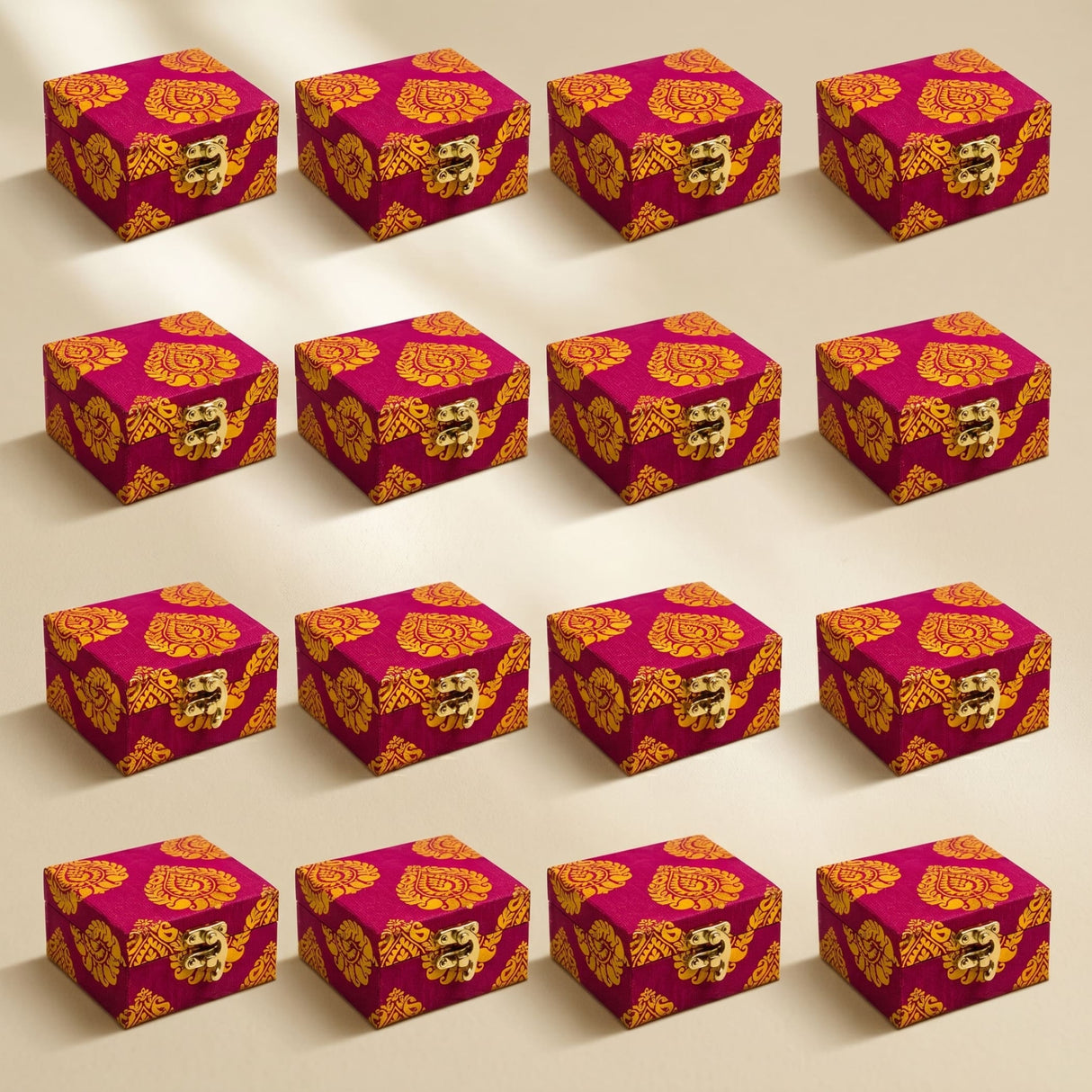 Small handmade vibrant magenta and gold brocade fabric jewelry boxes with ornate brass latches for indian pakistani wedding favors