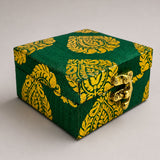 Small handmade jewelry box in green and gold brocade fabric with paisley pattern and brass clasp for indian wedding favors