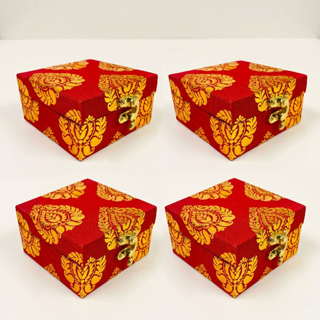 Red fabric gift boxes with gold damask patterns and brass clasps designed for traditional indian wedding and festive use