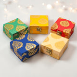 Five small handmade square brocade jewelry boxes in vibrant colors with gold paisley patterns for Indian pakistani weddings