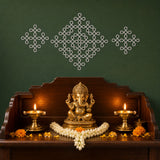 Golden brass ganesha statue seated on pedestal with intricate carvings and jasmine flowers for puja mandir decor