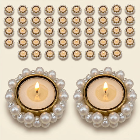 Elegant gold-rimmed tealight holders adorned with pearls and crystals in teal featuring lit candles for festive decor