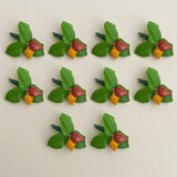 Haldi kumkum packets bulk with green and red fruit-shaped plastic hair clips featuring yellow accents for festive use