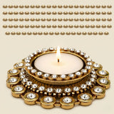 Gold-colored ornate tea light candle holder diya with clear crystal embellishments for Diwali and festive home decor