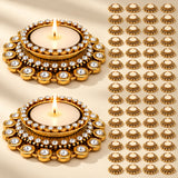 Gold-colored tea light candle holder diya with clear crystal embellishments and white candle for Diwali home decor