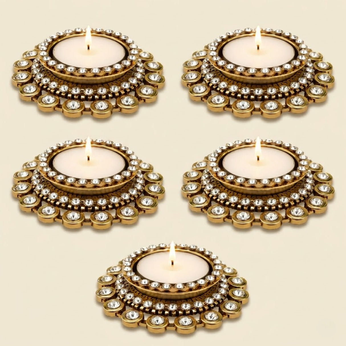 Gold-colored ornate tea light candle holder with clear crystals and intricate metalwork for traditional Diwali and pooja decor