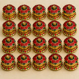 Traditional floral red haldi kumkum holder featuring red and green enamel flower buttons with gold-toned metal centers