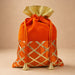 Orangish-red velvet potli bag with gold metallic lattice embroidery and tassels for Indian festive and wedding use
