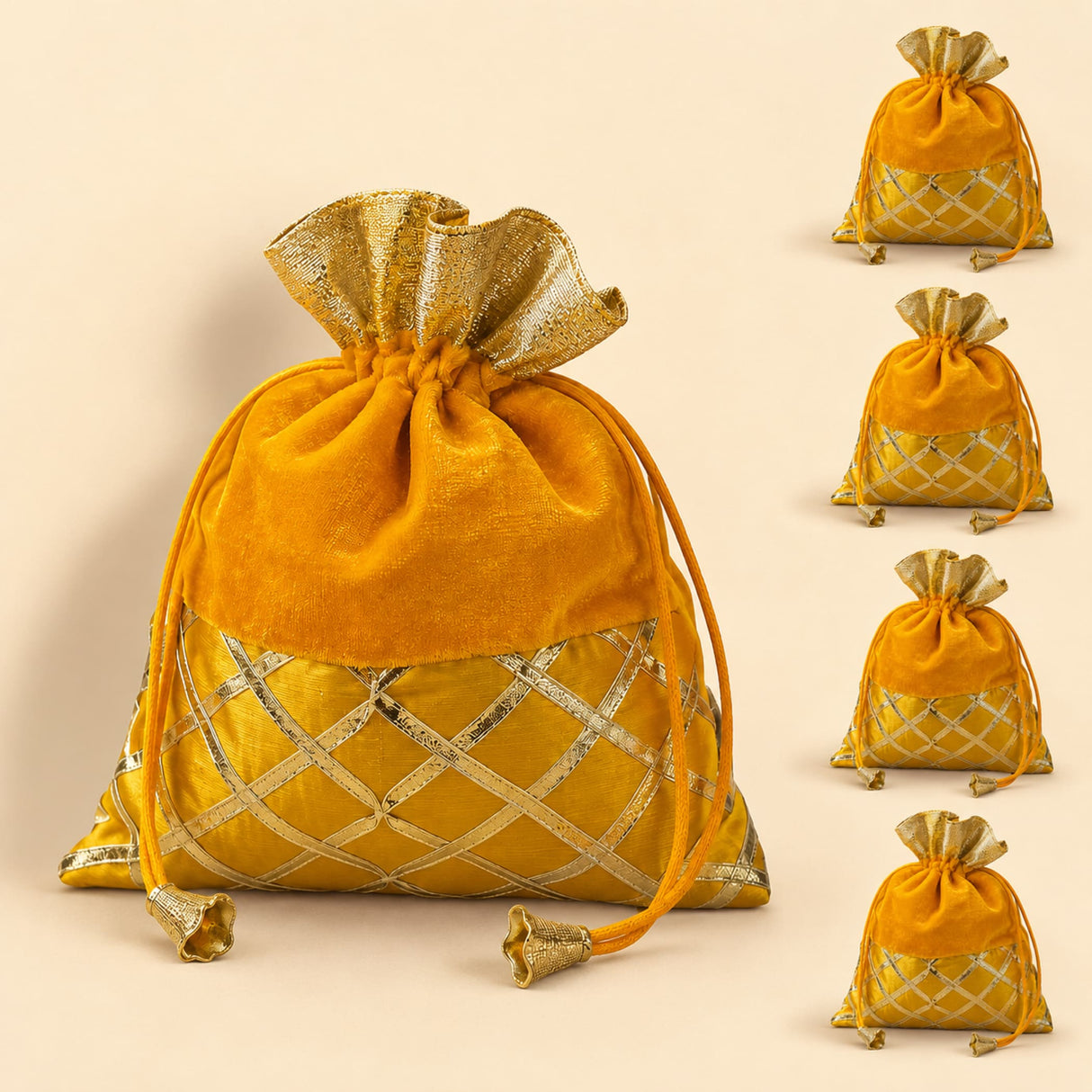 Traditional Indian velvet potli bag in gold with gota patti work and ornate tassels for festive and wedding use