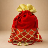Red velvet drawstring potli bag with gold metallic lattice and matching bow for pooja eid festive party and wedding gifts