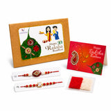 Traditional lumba rakhi set for brother and bhabhi with red and gold bracelet featuring ornate central embellishments