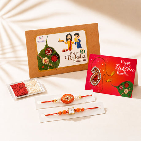 Traditional lumba rakhi set featuring orange beaded rakhi with ornate circular pendant and gold tone accents for brother and bhabhi