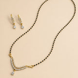 Gold-plated mangalsutra with black beads and clear stones paired with matching earrings for Indian bridal jewelry gift