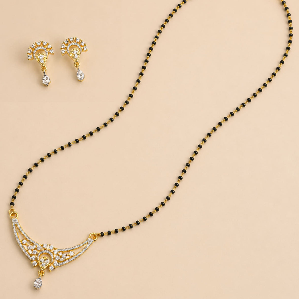 Gold-plated mangalsutra for women with black bead chain crescent pendant adorned with crystals and matching earrings for bridal use