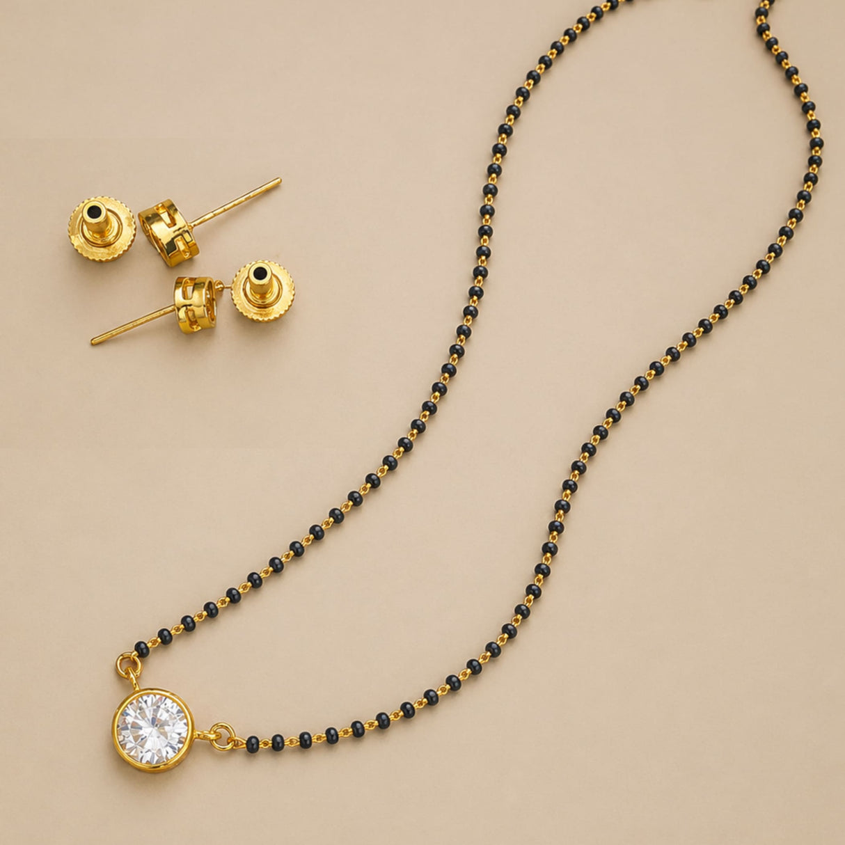 Gold-toned mangalsutra necklace with black beaded chain and round clear crystal pendant for Indian bridal jewelry set