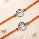 Two orange cord bracelets featuring silver-toned tree of life charm with cut-out design for raksha bandhan gift