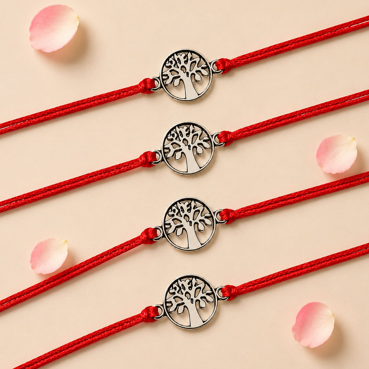 Four red cord tree of life charm rakhis with silver toned intricate cut out detailing for brother and bhabhi