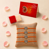 Four orange cord bracelets with silver tree of life charms on burlap pillow traditional raksha bandhan jewelry gift