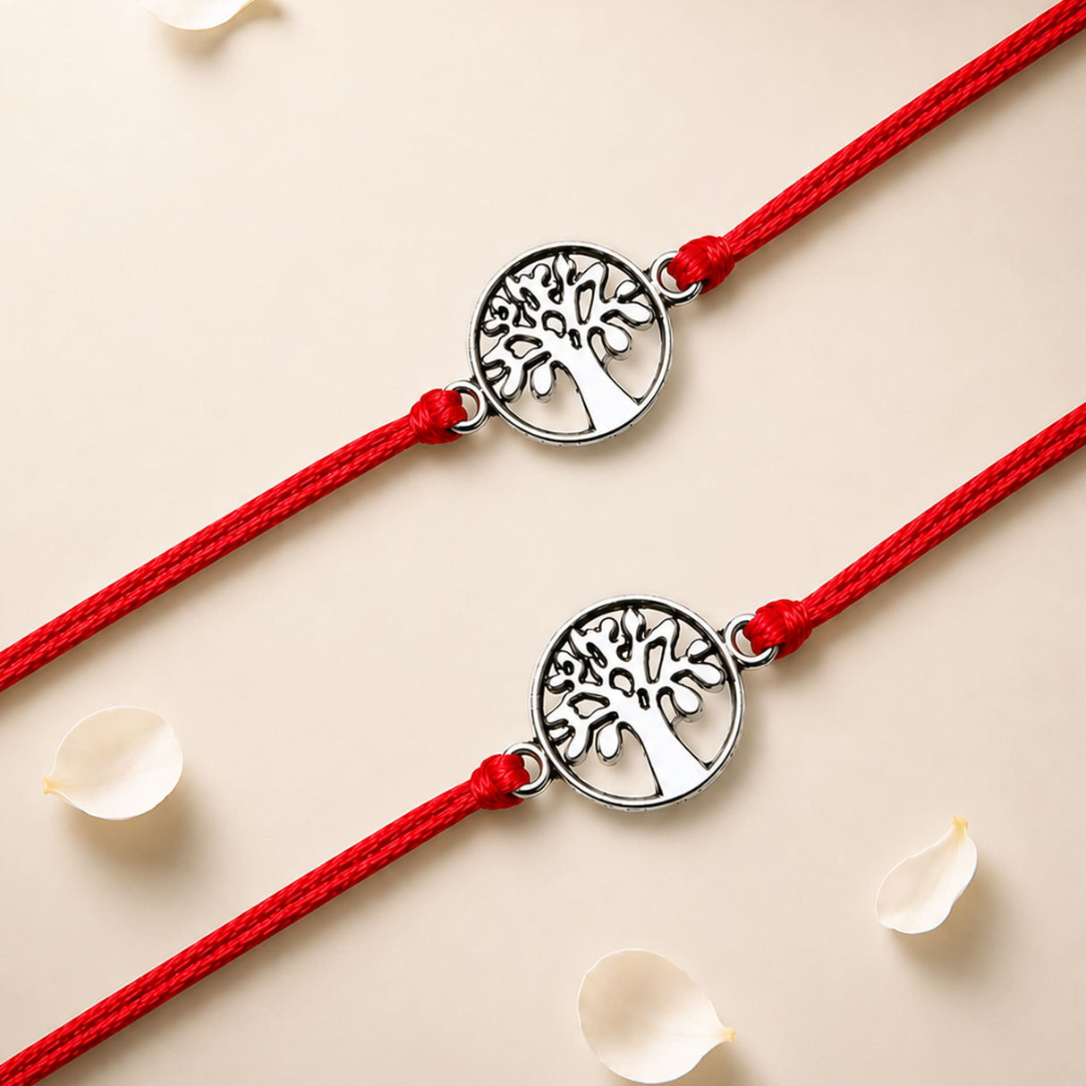 Two red cord tree of life charm rakhis with silver toned circular charms for brother and bhabhi protection gift