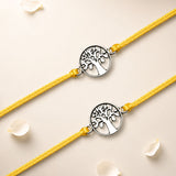 Two yellow cord tree of life charm rakhis with silver-toned intricate cut-out design for brother and bhabhi