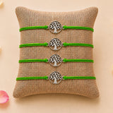 Four vibrant green cord bracelets with silver-toned tree of life charms for traditional raksha bandhan protection gift