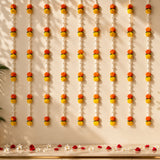 Vibrant orange and yellow marigold flower garlands hanging vertically for tuberrose mogra string diwali and wedding decor