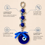Blue glass turtle charm with silver metal accents and matching blue ribbon bow in evil eye hanging decoration