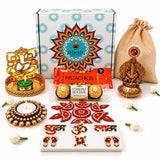 Gold-colored ganesha figurine with intricate detailing and red gemstone in ultimate diwali gift hamper for festival celebration