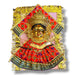 Golden Hindu deity figure with ornate red and green fabric for Varalaxmi Vratam puja