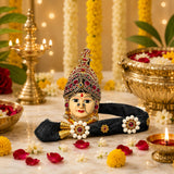 Golden ornate vara lakshmi goddess face idol with red and white gemstone embellishments for navaratri pooja