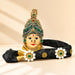 An ornate black Vara Lakshmi goddess face headpiece with jeweled accents and floral embellishments for Navaratri pooja