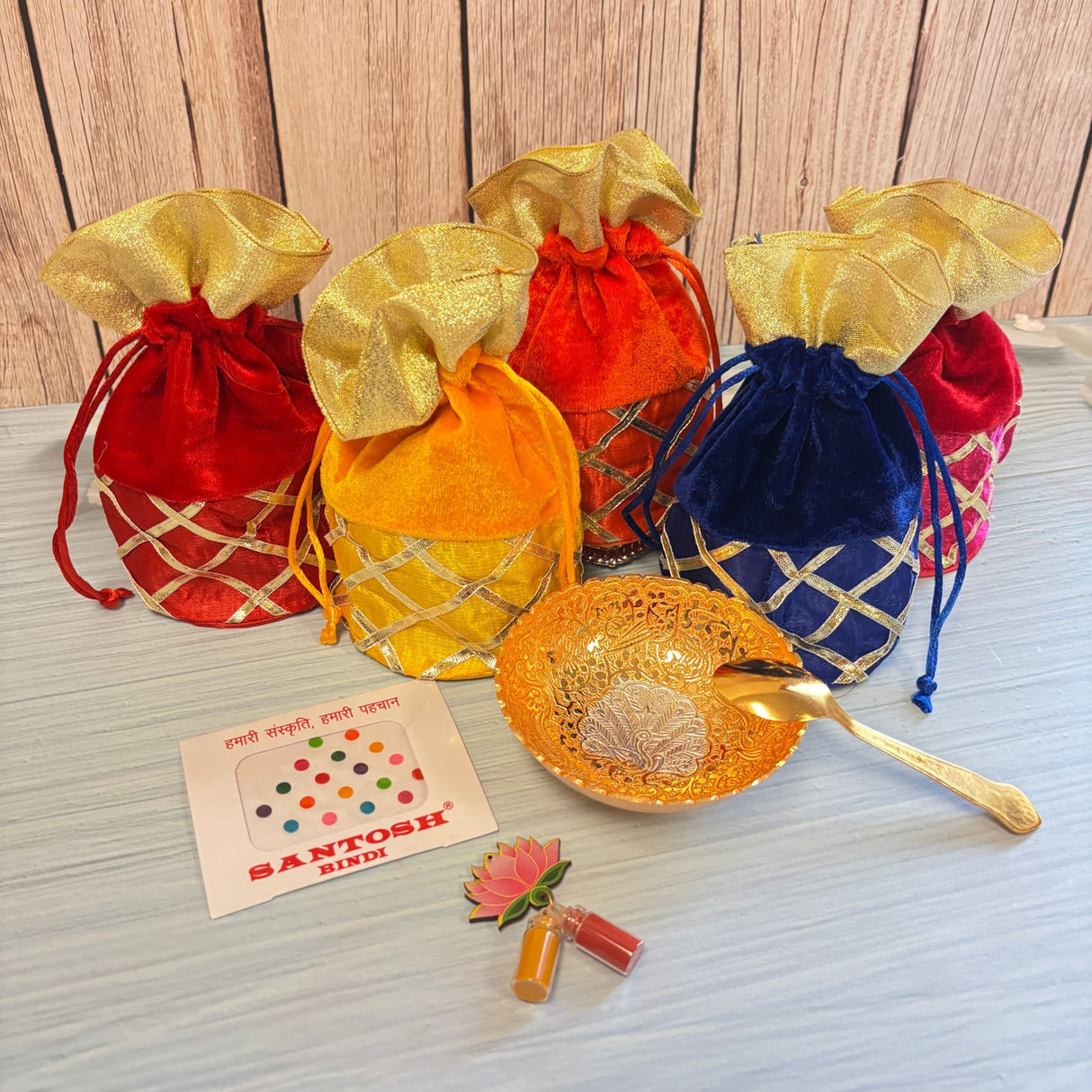 Gold-colored ornate bowl with intricate silver filigree and matching gold spoon in varalakshmi vratham gift hamper for pooja