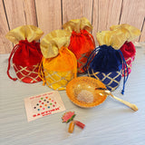 Gold-colored ornate bowl with intricate silver filigree and matching gold spoon in varalakshmi vratham gift hamper for pooja