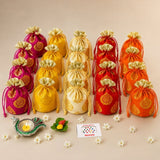 Vibrant embroidered drawstring pouches in pink yellow red and orange with gold paisley for Varalakshmi Vratham gift hamper