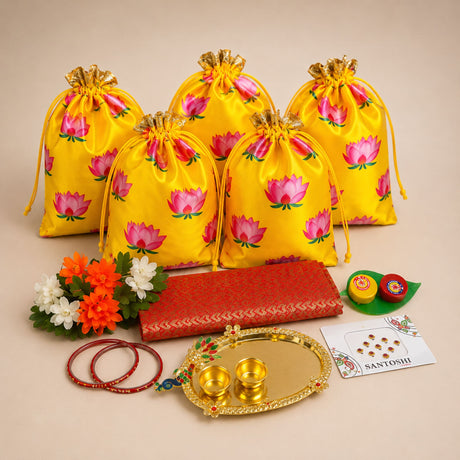 Bright yellow satin drawstring potli bags with pink lotus prints and gold-tipped cords for navaratri and puja gifts