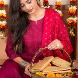 A woven wicker basket with a handle containing beige fabric and orange marigold flowers in Varalakshmi Vratham gift hamper