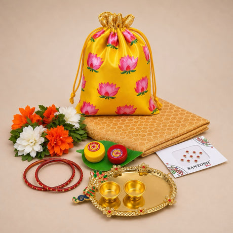 Yellow satin drawstring potli bag with pink lotus prints and gold trim in varalakshmi vratham gift hamper for women