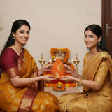 Orange gold silk potli pouch with intricate designs for Navaratri pooja gifts