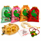 Four satin drawstring potli bags in mint green pink gold and red with green parrot design for varalakshmi vratham gift hamper