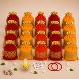 Red and orange velvet drawstring potli bags with gold embroidered patterns for varalakshmi vratham and hindu religious gifts