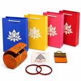 Orange embroidered cylindrical bangle box with gold thread detailing and silver clasp in varalakshmi vratham gift hamper