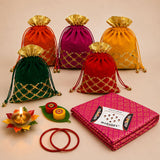 Vibrant velvet potli bags in orange magenta yellow green and red with gold lattice embroidery and golden tops for religious gifts